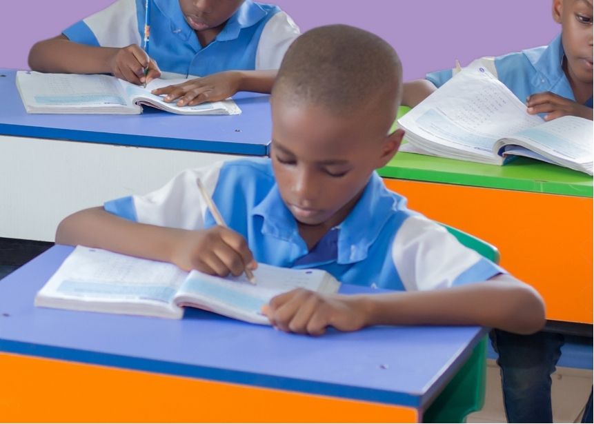 A Dandave School pupil completing handwriting practice at his desk